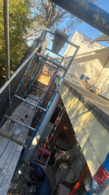 Scaffolding beside the upper balcony and brick exterior