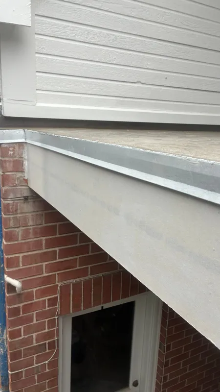 Metal edge detail beneath a balcony doorway