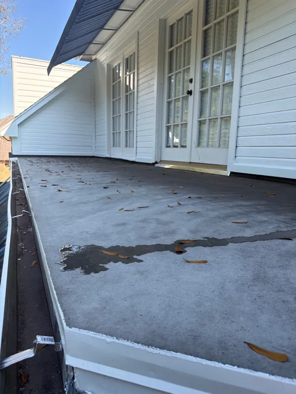 Later view of the balcony floor and white exterior doors