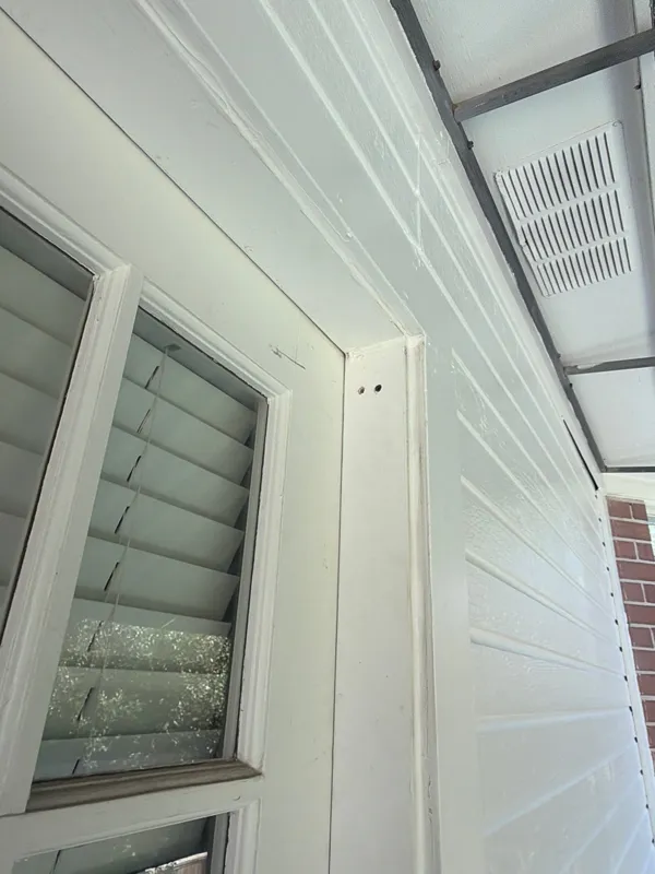 White siding and trim adjoining exterior doors