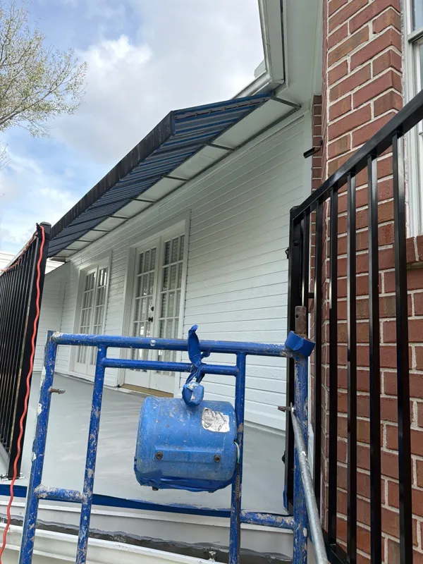 Scaffolding and railing beside the upper exterior