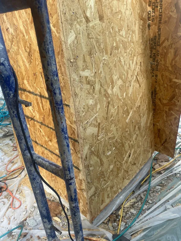 Wood sheathing beside a window during repair work
