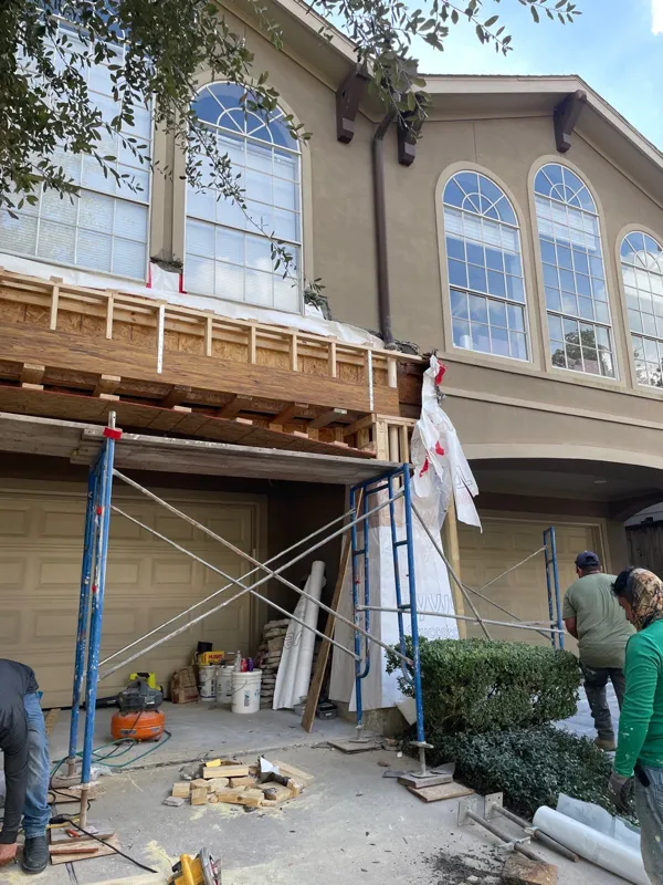 Scaffolding in front of arched upper-story windows