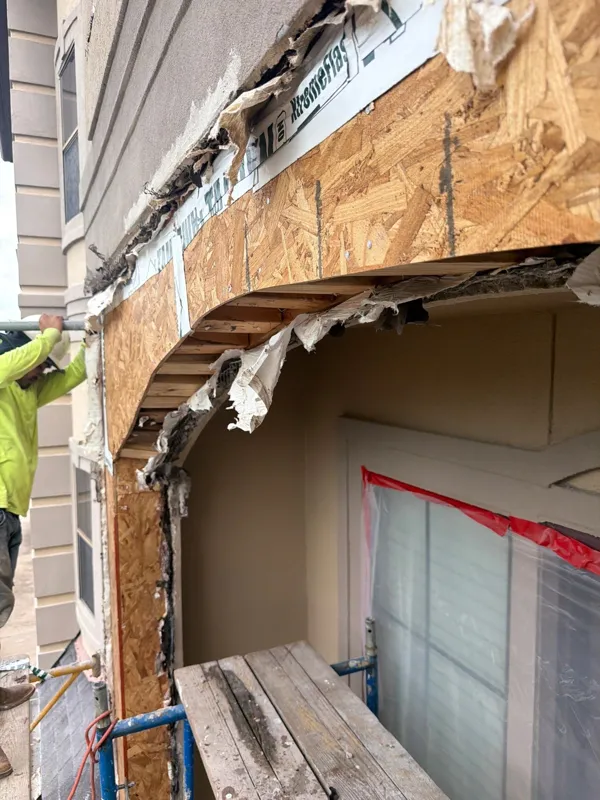 Exposed sheathing around an arched window opening