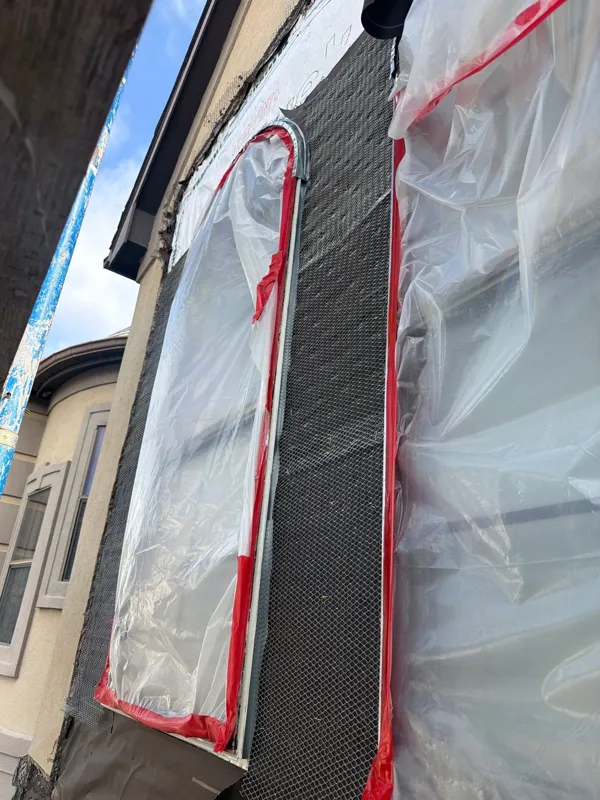 Masked window and weather barrier during exterior work