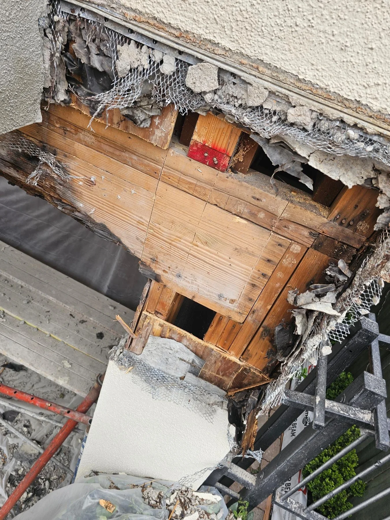 Opened balcony edge showing wood and exterior layers