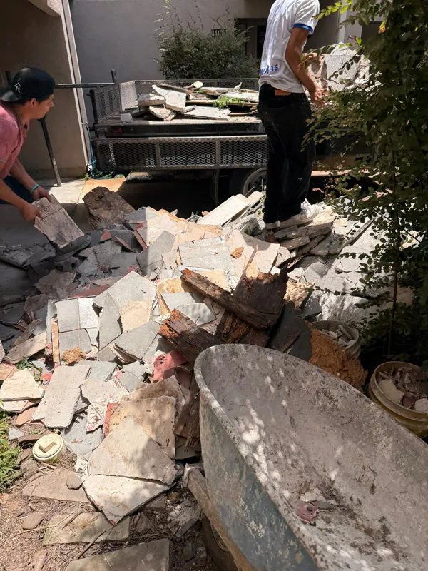 Removed material beneath a balcony repair area