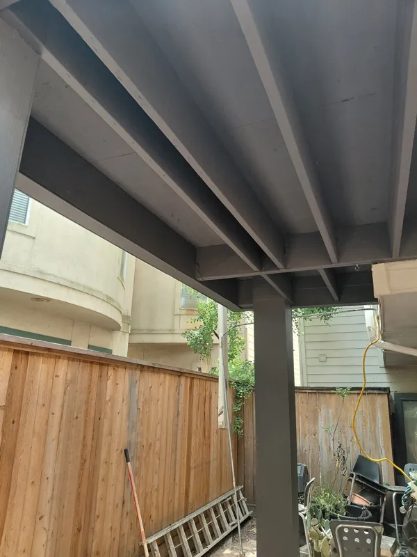 Painted structural members beneath the balcony