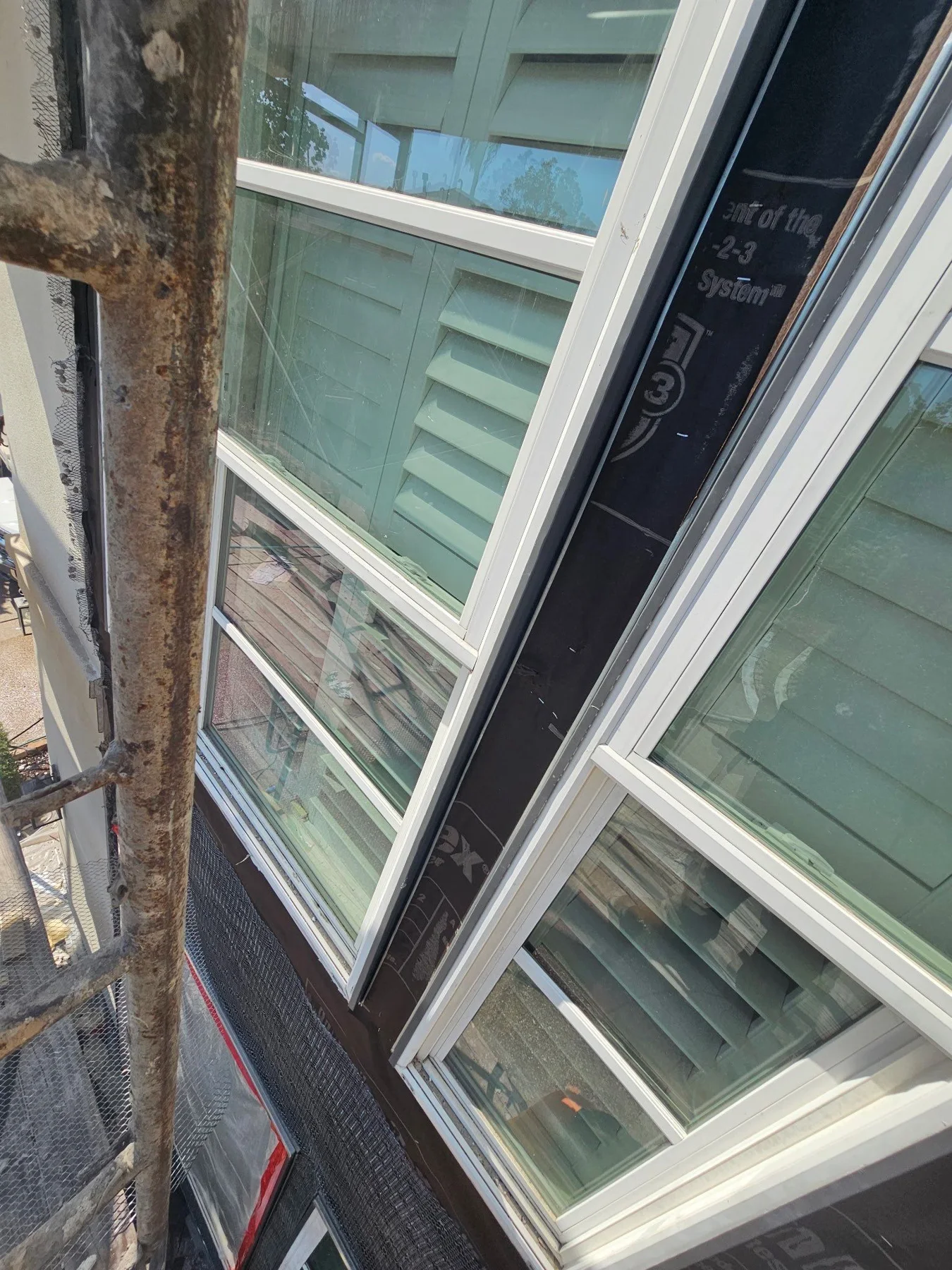 Weather barrier and flashing around a protected window