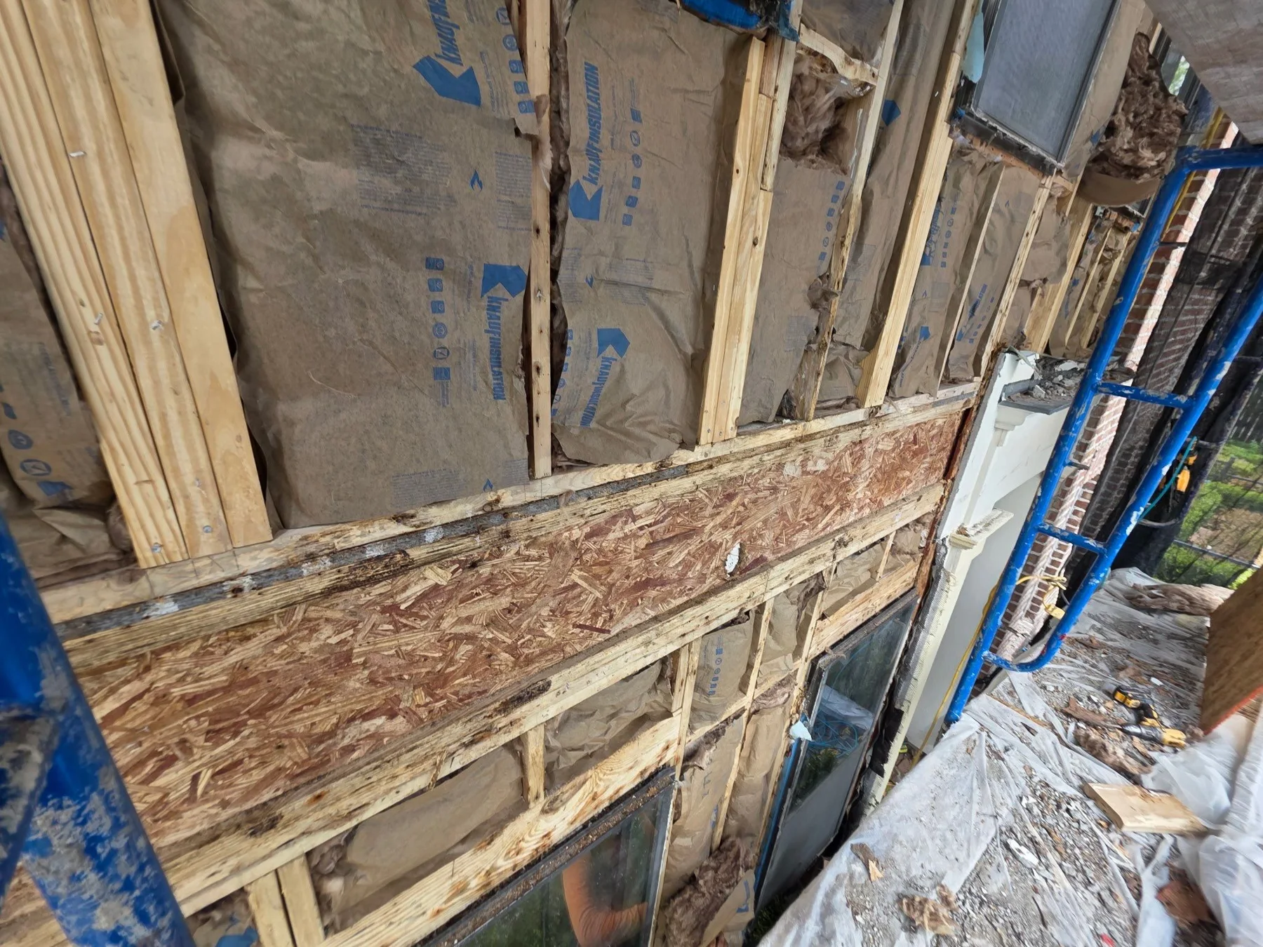 Exposed framing and sheathing behind an exterior wall