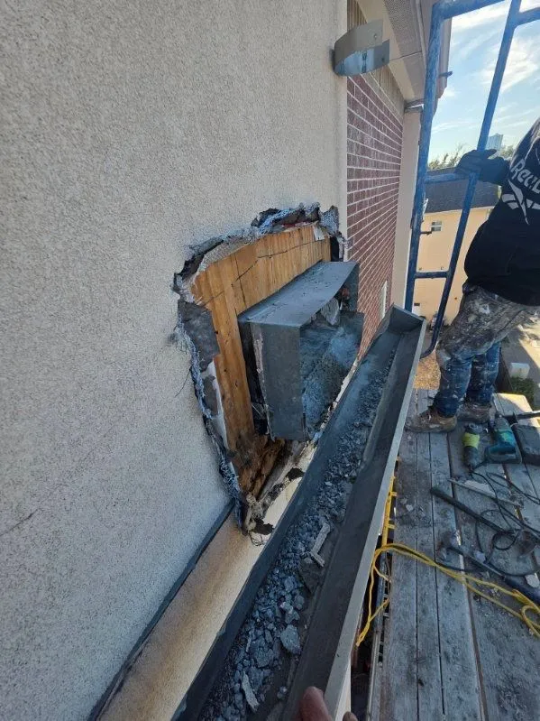 Opened wall area beside an exterior railing