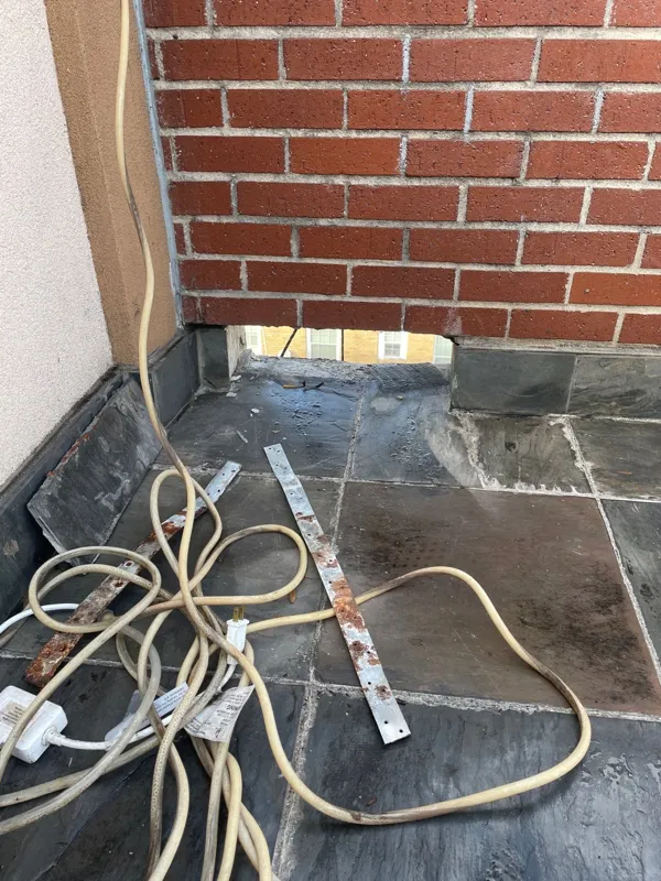Stucco and brick junction near an exterior platform