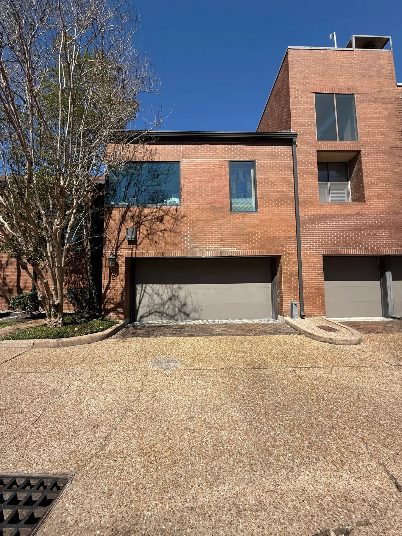 Brick townhome and driveway documented for a foundation assessment