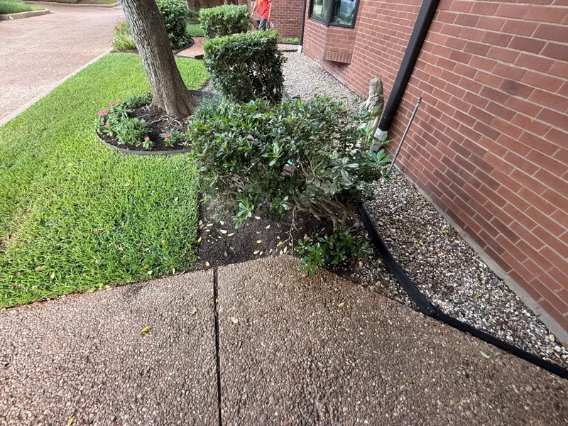 Walkway beside the brick wall and front planting bed