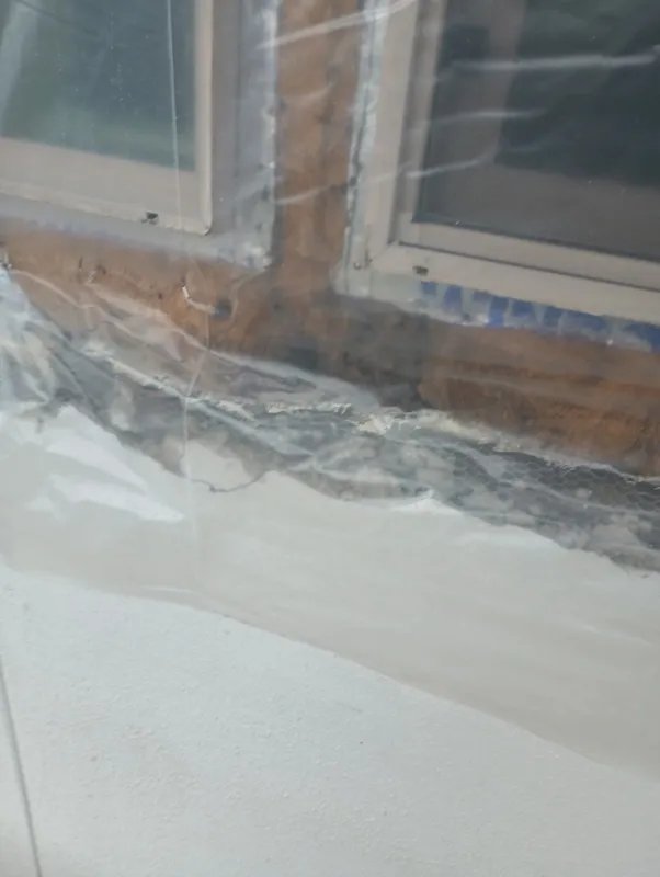 Opened material below a wide exterior window