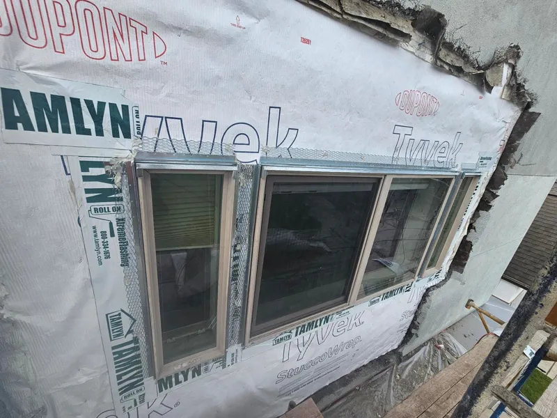 Weather barrier installed around a wide window