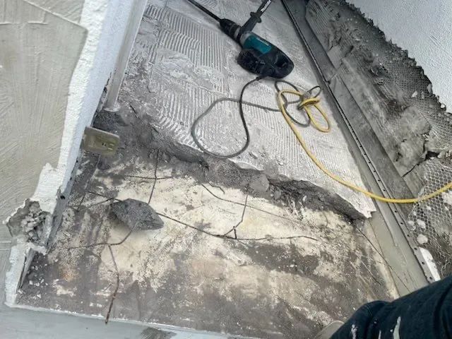 Opened exterior surface beside a railing