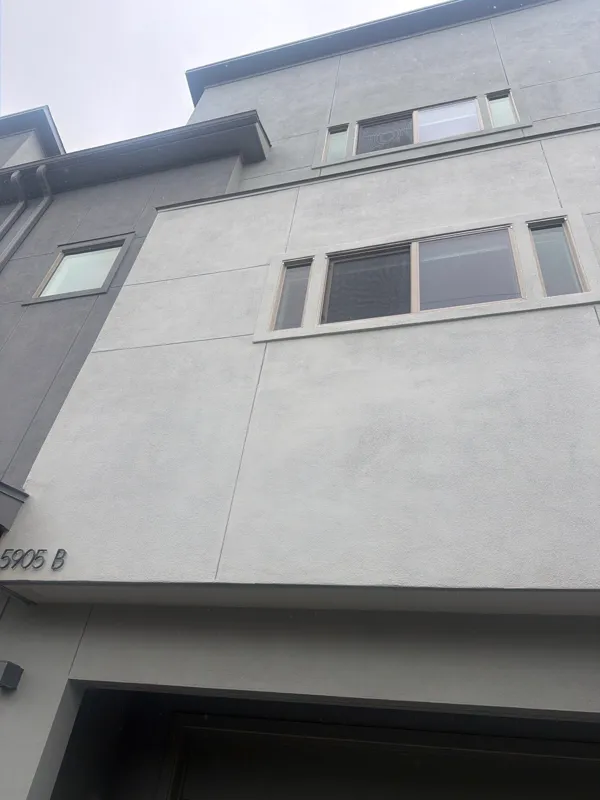Light stucco wall and horizontal windows above the garage
