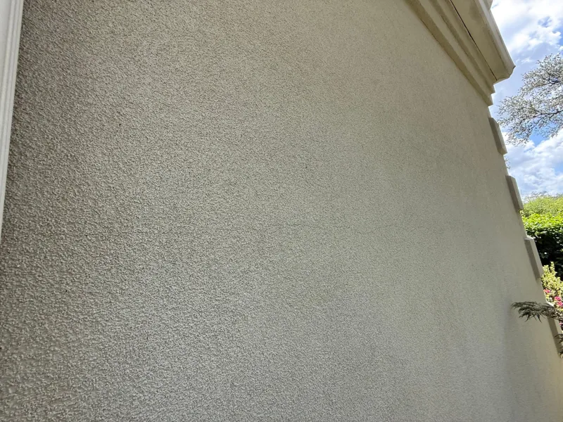 Close view of a textured stucco wall beneath the trim