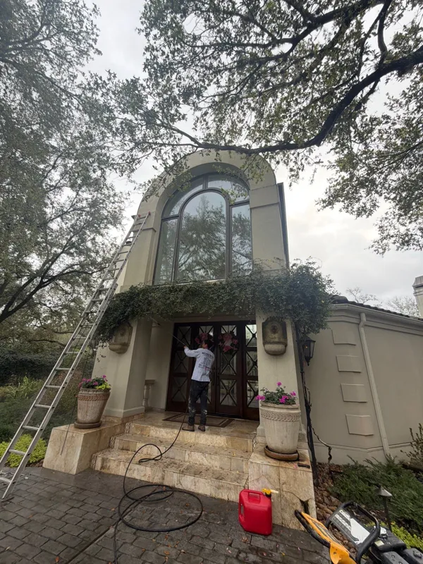 Arched entry elevation with ladders and painting supplies