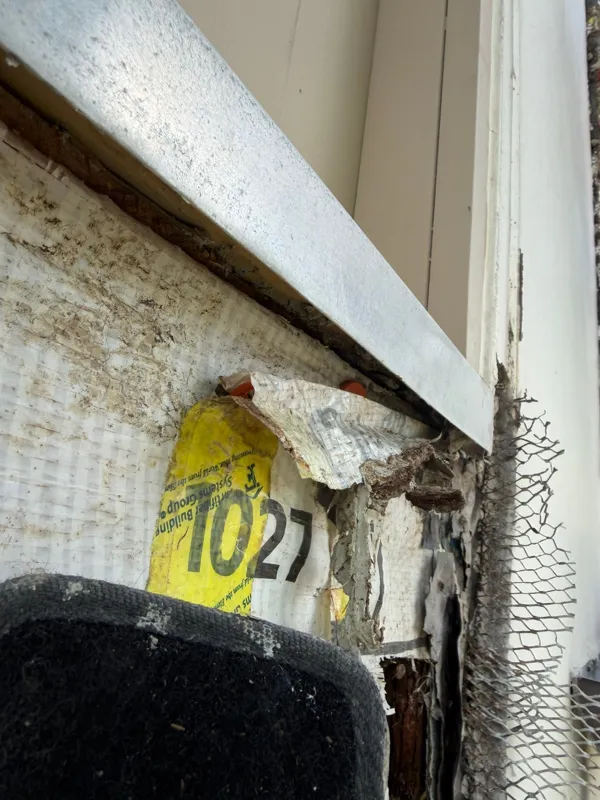 Opened material beneath an exterior window edge