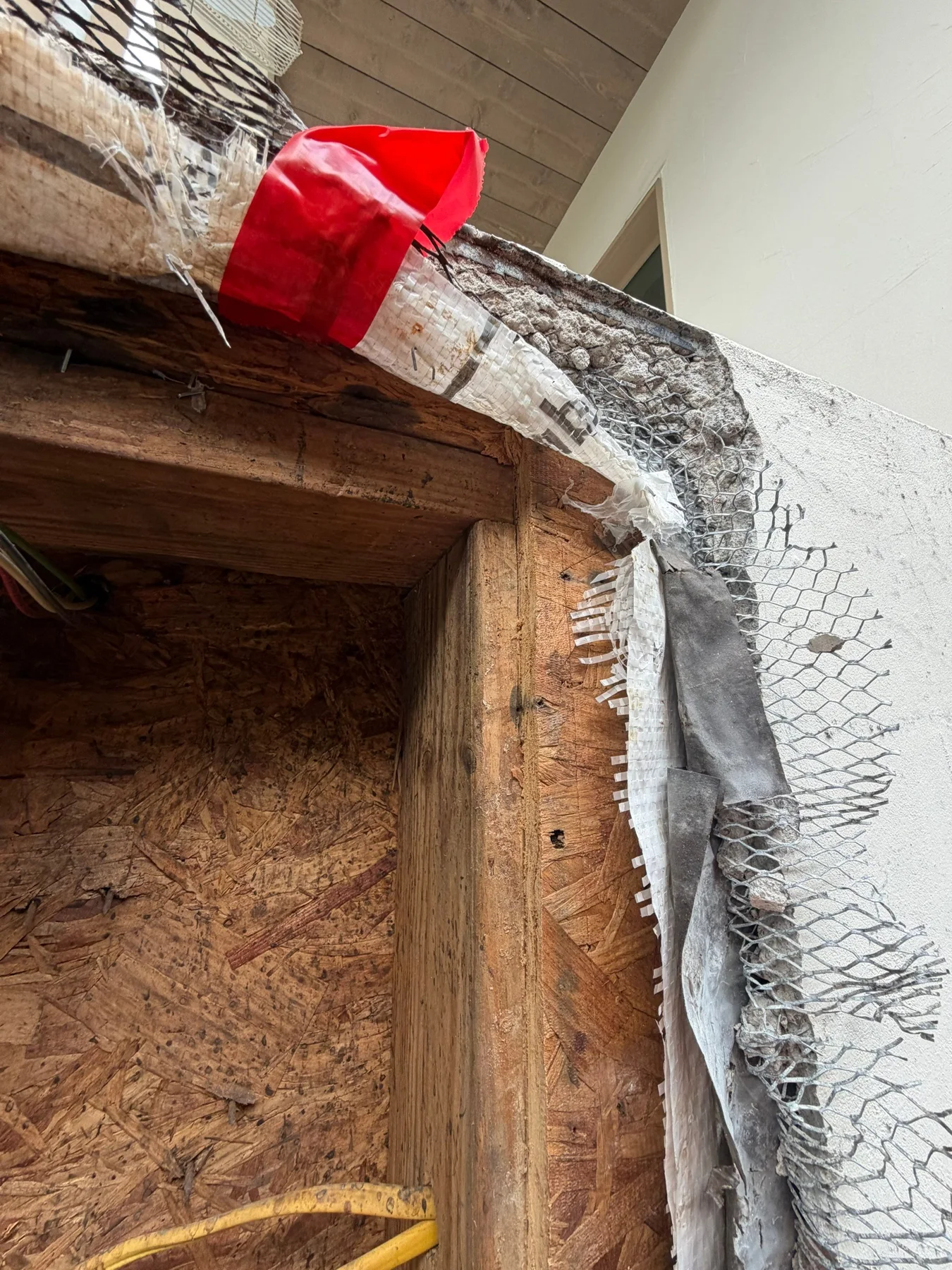 Wood sheathing revealed around the repair area