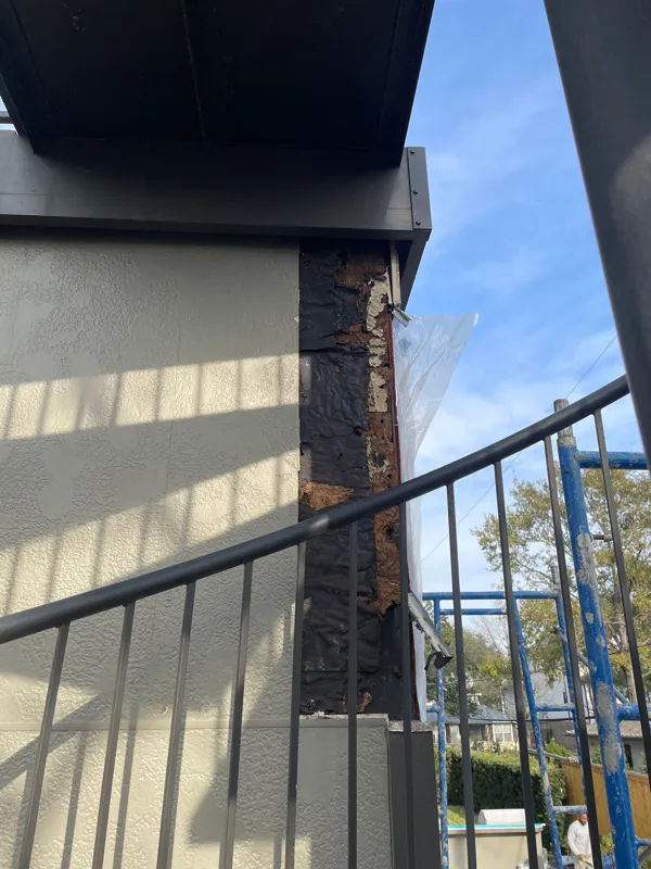 Exterior wall and railing near a tall window