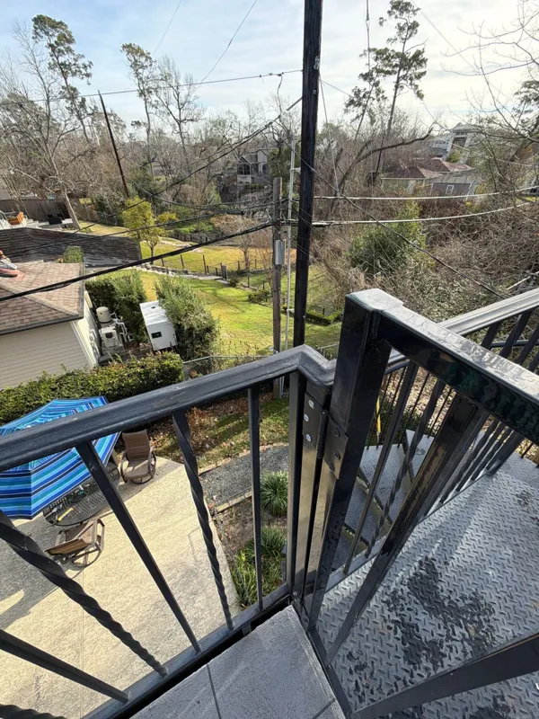 Deck railing and outdoor view in a later project photograph
