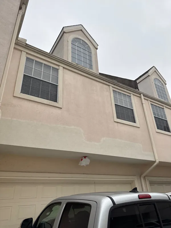 Stucco facade and garage during exterior work
