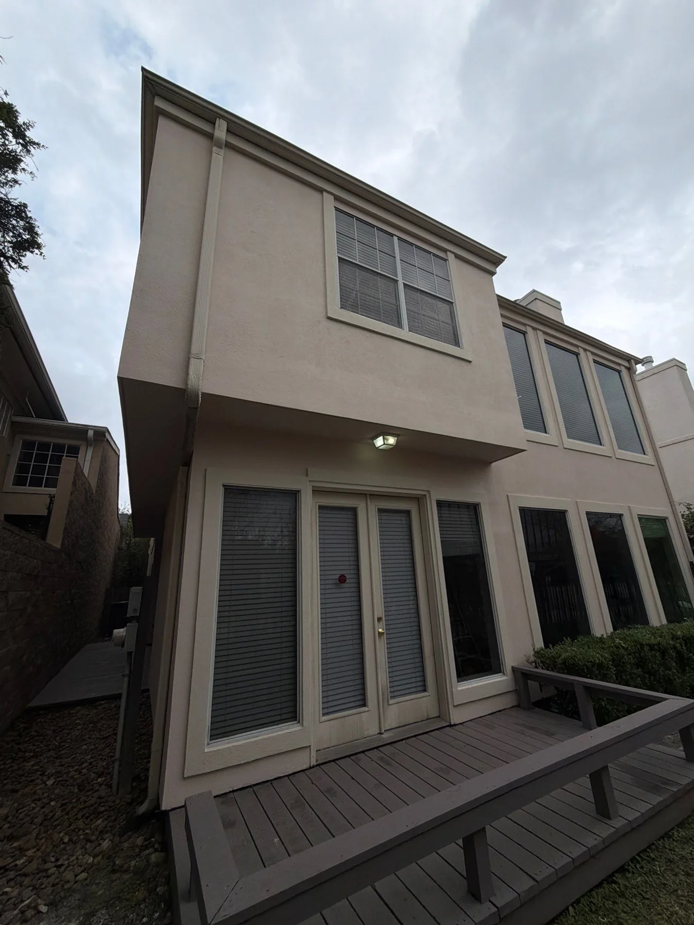 Later view of the townhome’s light stucco facade
