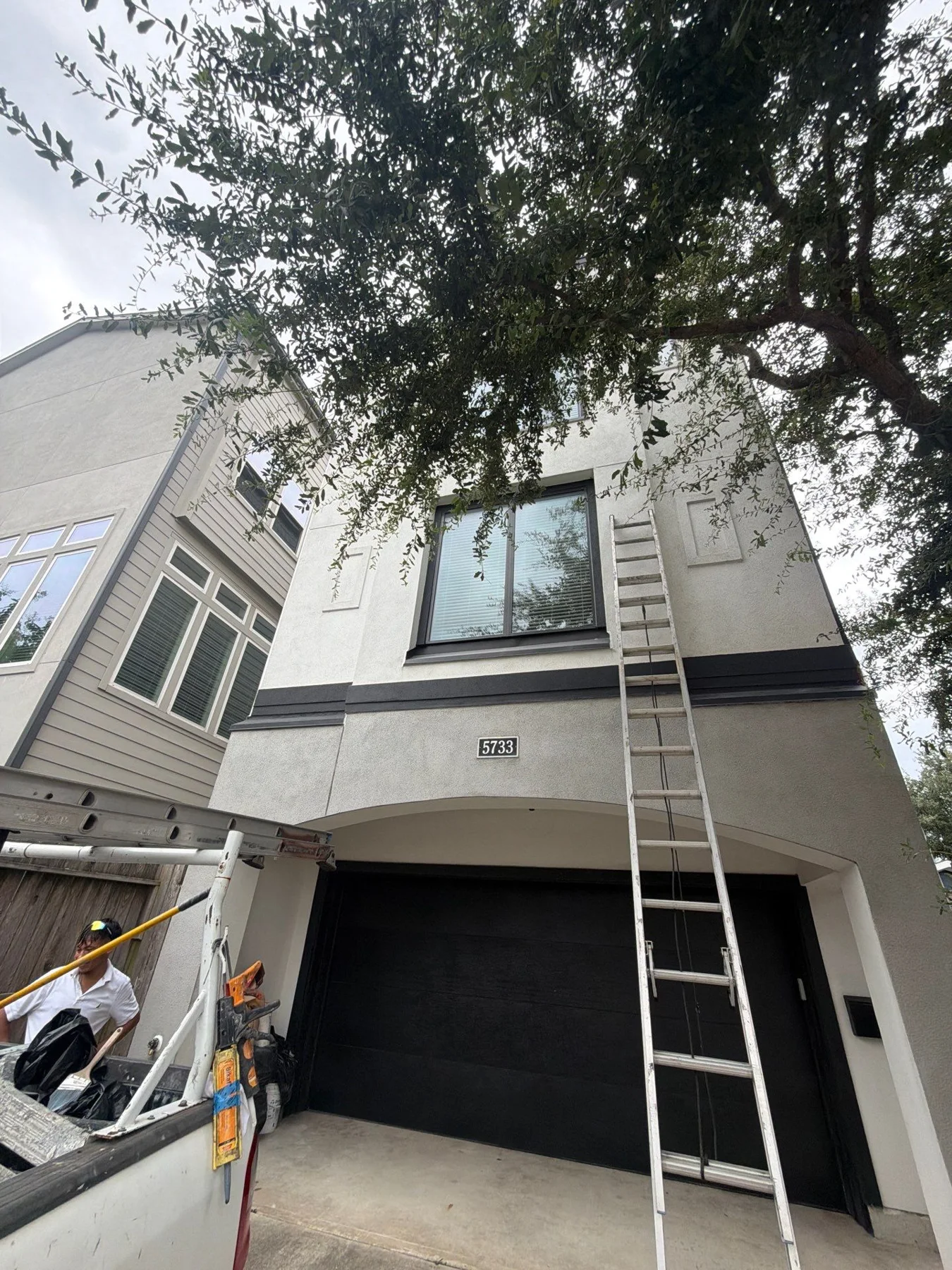 Gray and white home exterior viewed from the driveway
