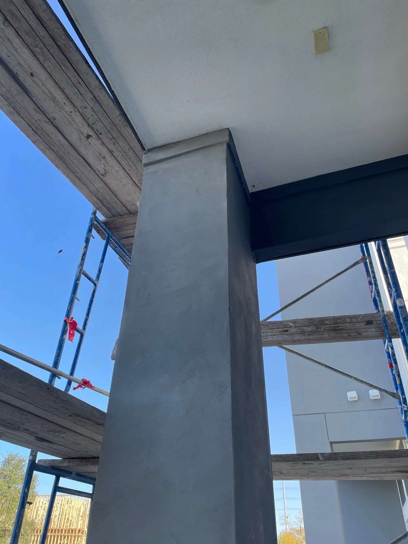 Stucco work around an exterior column and soffit