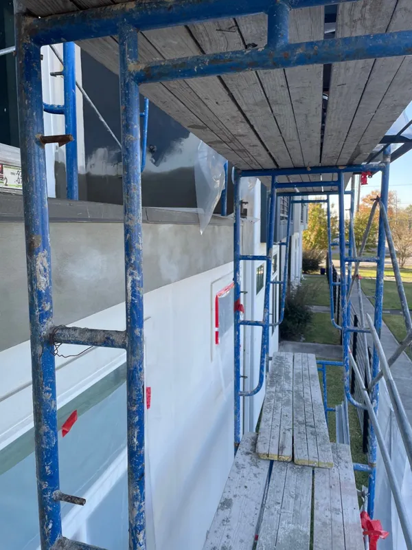 Protected wall and balcony openings behind scaffolding