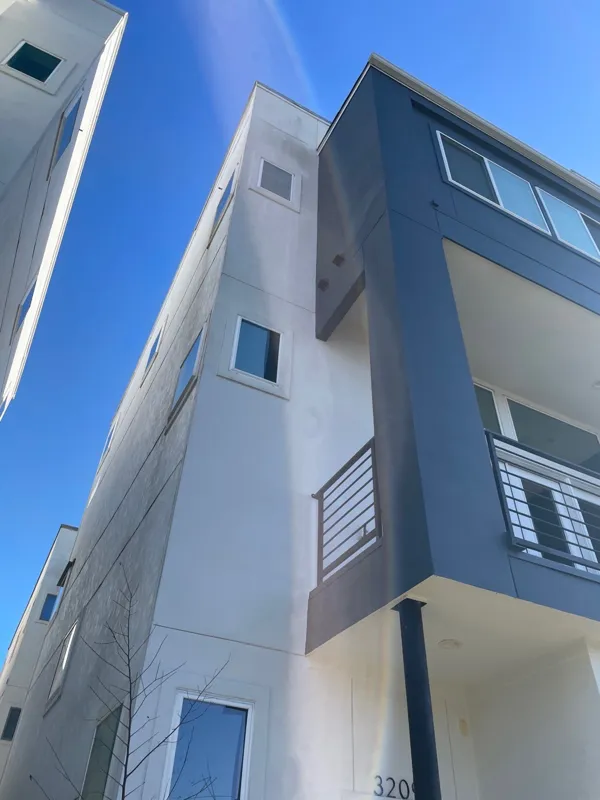 Upper stories of a modern stucco building