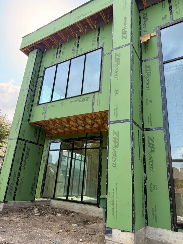 Green exterior sheathing around upper-story windows