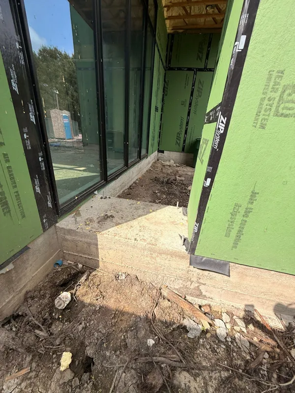 Sheathing and flashing at a ground-floor opening