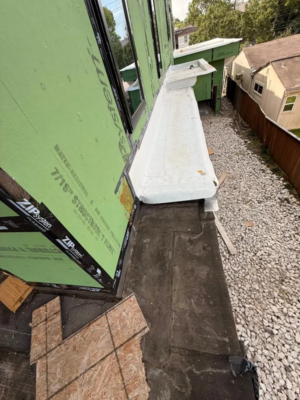 Flashing and sheathing at the base of an exterior wall