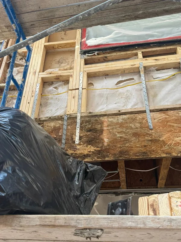 Exposed wood and framing around an exterior window
