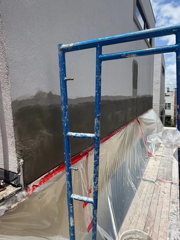 Fresh exterior coating beside scaffolding