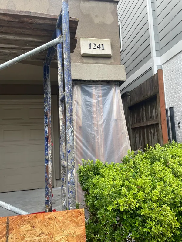 Protected exterior opening beside a landscaped patio area