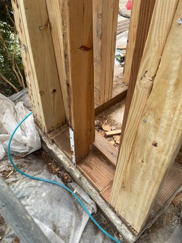 Wood framing visible behind the opened exterior wall