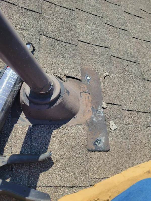 Metal flashing at the base of a roof vent