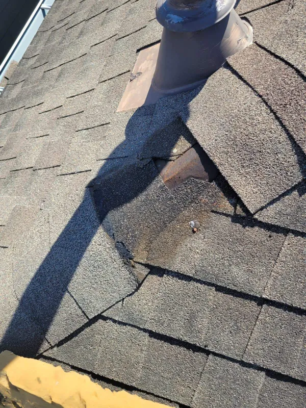 Metal flashing edge over a shingle roof