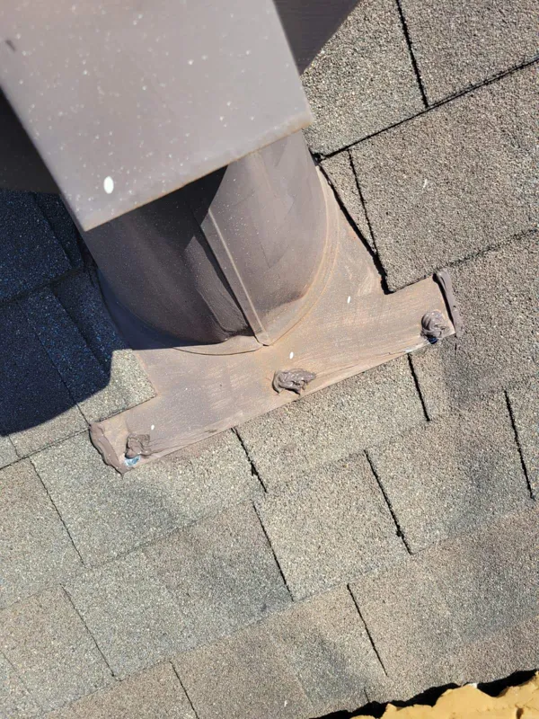 Later close view of the vent base and surrounding shingles
