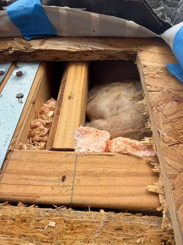 Wood framing inside the opened repair area