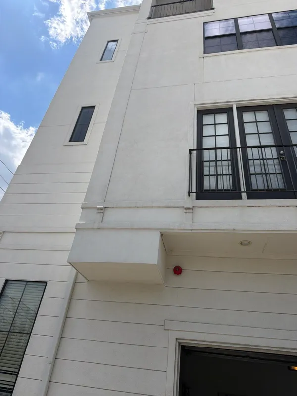 White stucco facade and black-framed windows
