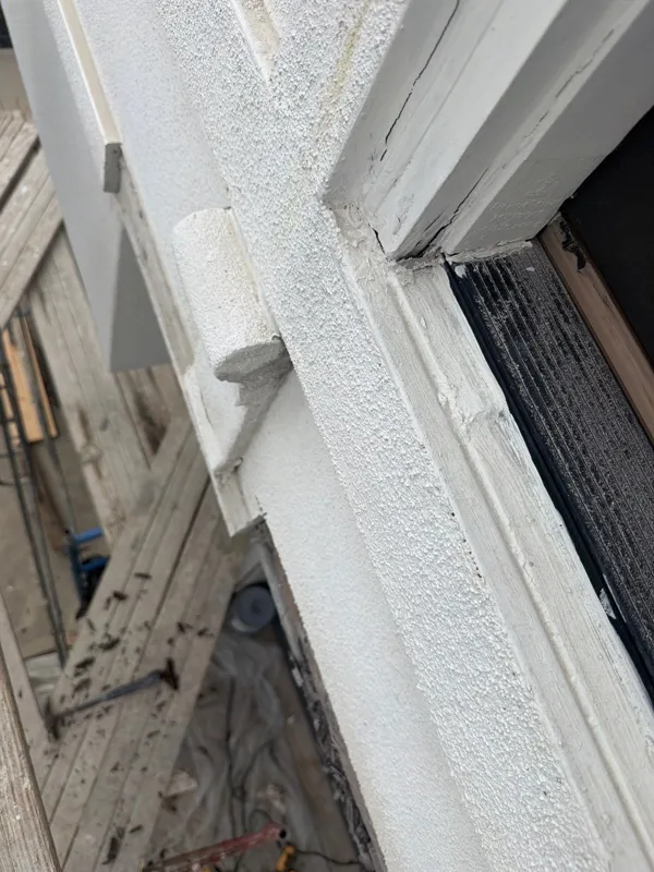 Exposed exterior layers beside a window