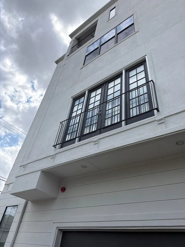 White stucco facade with black window detailing