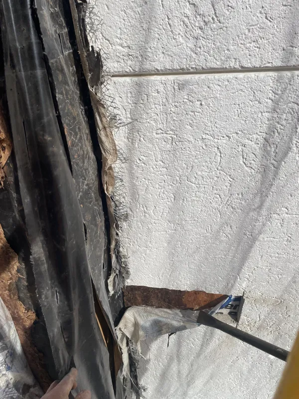 Exterior wall edge opened to reveal underlying material