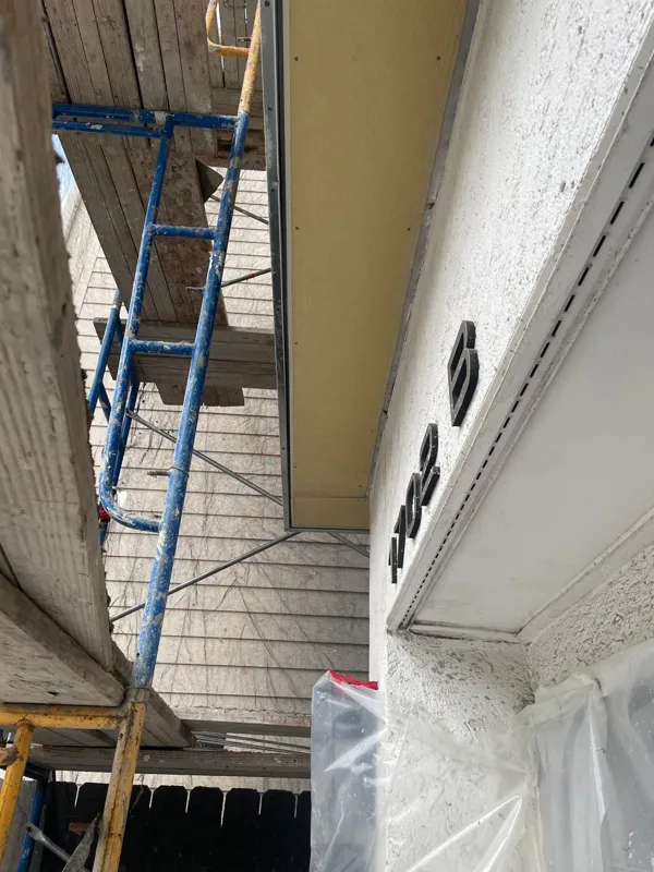 Scaffolding beside a narrow exterior passage